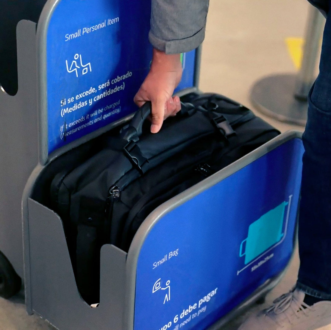 Analog Cases Trakpack Roll being test-fitted in an airline carry-on sizer at the airport