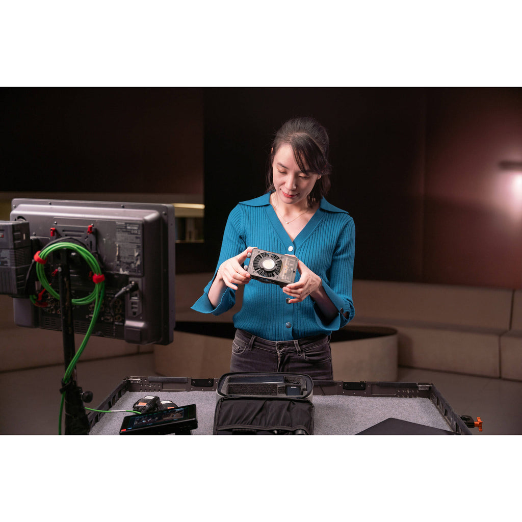Zhiyun Molus X100 Pro bi-color LED light panel with adjustable brightness and color temperature, mounted on a filming stand.