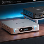 FiiO AIR AMP in Silver on a desk beside a screen streaming music