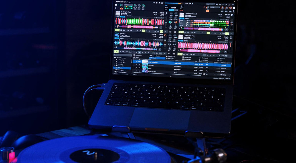 Native Instruments Traktor Pro 4 DJ software interface displayed on a computer screen, featuring waveforms and control panels.