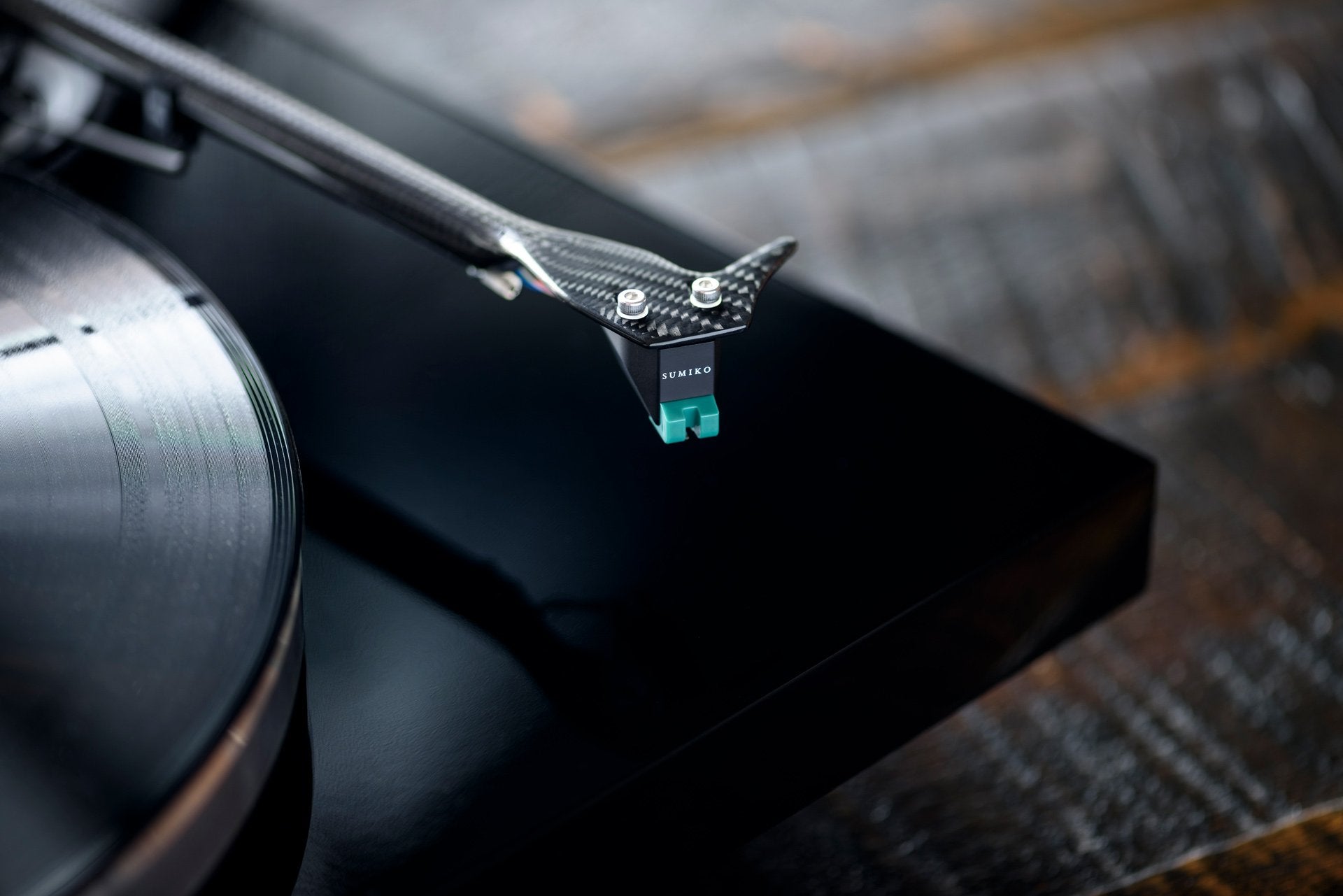 Sumiko Olympia MM phono cartridge mounted on a turntable, showcasing its sleek design and stylus for high-quality audio playback.