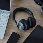 Technics EAH-A1000 in Black on a desk next to a laptop and phone
