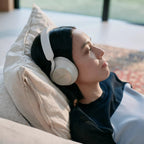 Technics EAH-A1000 in Platinum Greige worn while lying on a sofa
