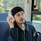 Technics EAH-A1000 in Platinum Greige worn on a train